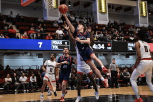 Jake Warnock soars to the hoop against Peekskill at the Westchester County Center.
